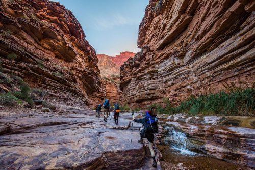 Climbers hiking through a beautiful canyon of rocks